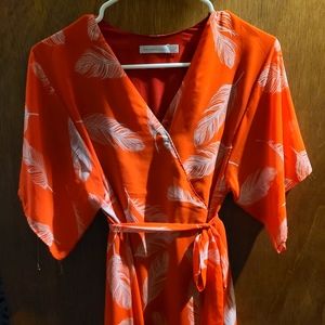Worn 1x long flowy dress.  Looks orange/red with feathers and peacocks